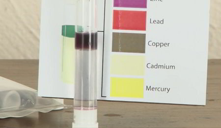 Heavy metal test kit showing test tube and labeled color key