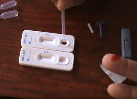 HIV home test kit receiving a drop of blood using a dropper