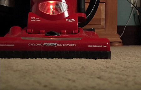 Red vacuum cleaner with HEPA filter to remove allergen particles